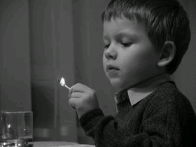 image of child holding a match