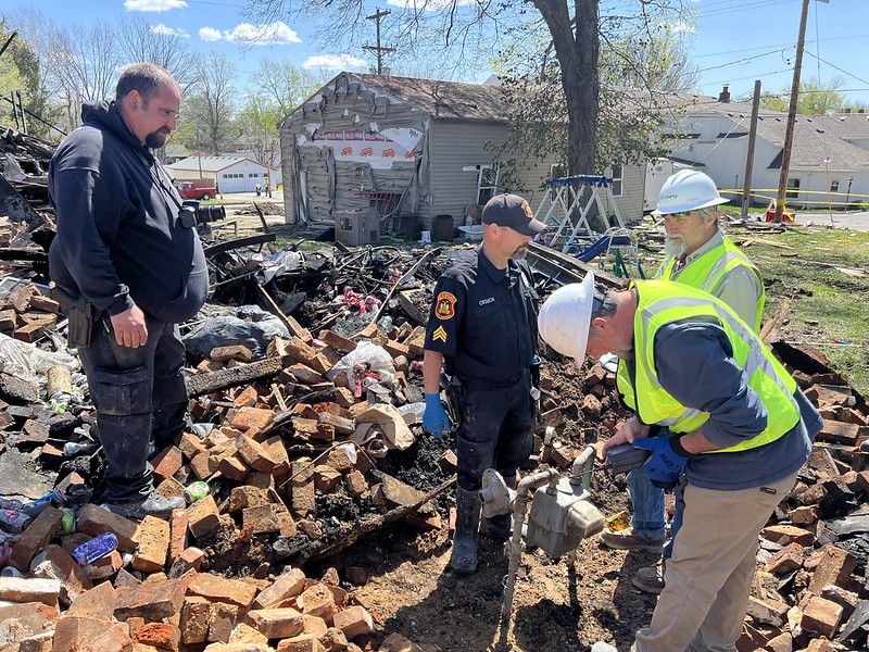 fire investigator digging through rubble