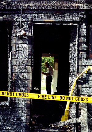 fire investigator digging through rubble